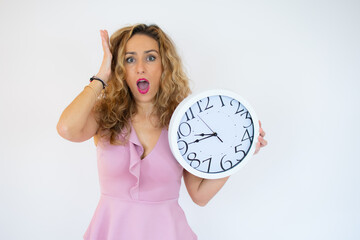 Surprised woman holding Big Clock, isolated on white background. Portrait of woman showing big clock with Stress