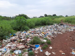 garbage on the forest, garbage dump in the forest, plastic pollution in the nature, garbage dumping in the forest. 