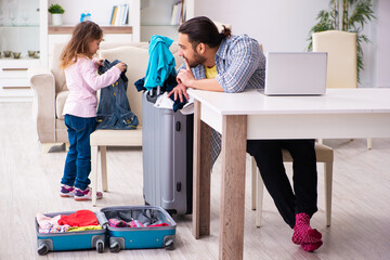 Young man and his small daughter preparing for the trip