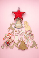 Conceptual Christmas tree made of wooden toys for Christmas on a pink background. Zero waste. Top View