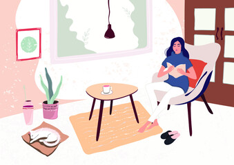 The girl is reading a book, engaged in self-development in quarantine due to the coronavirus. Female enjoying recreation and selftime. Interior with stylish furniture  in Scandinavian hygge style