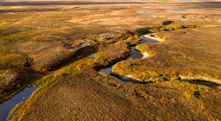 Landscape of the forest-tundra in autumn and the sandy river bank, bird's eye view.Arctic Circle, tunda. Beautiful landscape of  tundra from a helicopter.