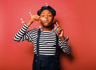 Little girl blowing bubbles