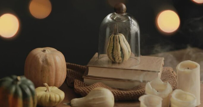 Halloween candles being blown out in an Autumn table