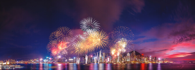 Panorama view of Hong Kong fireworks show in Victoria Harbor - 384976084