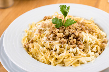 Turkish Noodle / Eriste with cheese, walnuts on wooden background