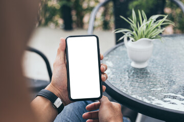 cell phone mockup blank white screen.man hand holding texting using mobile on desk at coffee shop.background empty space for advertise.work people contact marketing business,technology