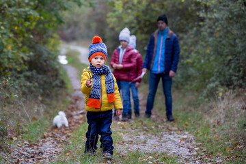 Happy children, running and jumping and playing in autumn colorful park