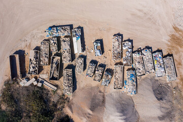 Trailer loaded with scrap metals parked in a Scrapyard, Aerial image.