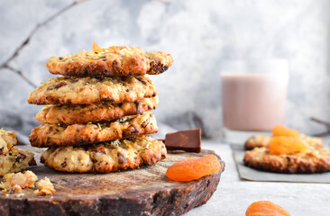 Oatmeal cookies. Homemade baking. Autumn concept of cookies with dried apricots and chocolate. Copy space. Light background.