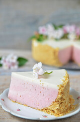 A piece of strawberry cheesecake on a saucer