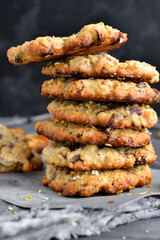 Oatmeal cookies. Homemade baking. Autumn concept of cookies with dried apricots and chocolate. Closeup. Dark background.