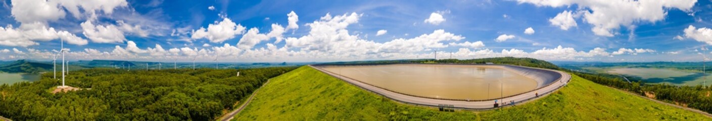 Panorama of Numerous wind turbines in the vast forest with mountains and sky as background at Khao Yai Thiang Lam Ta Khong Reservoir, Sikhio, Thailand. © powerbeephoto