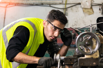 Fototapeta na wymiar Industrial Engineer working for machine maintenance at the factory.