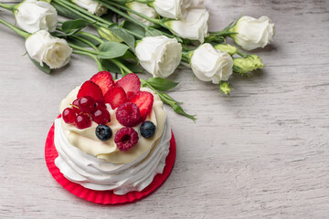 Pavlova meringue cake with cream and raspberries, blueberries, strawberries, currants