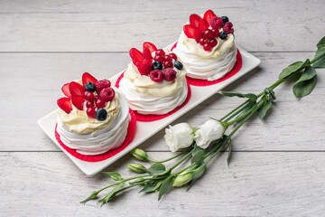 Pavlova meringue cake with cream and raspberries, blueberries, strawberries, currants
