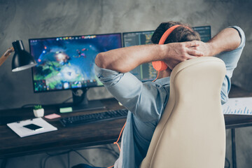 Rear back behind view of his he nice focused guy geek playing web network game remote freelance...