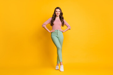 Full length body size photo of pretty girl with long hair wearing casual clothes smiling isolated on bright yellow color background