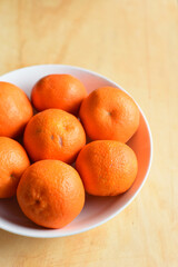 Fresh Oranges oin the Plate on Wooden Table
