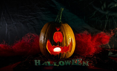 Halloween Pumpkin in dark atmosphere. Creepy smile, horror symbol - 384983882