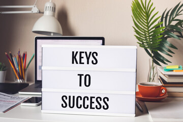 Keys to success concepts with text on light box.