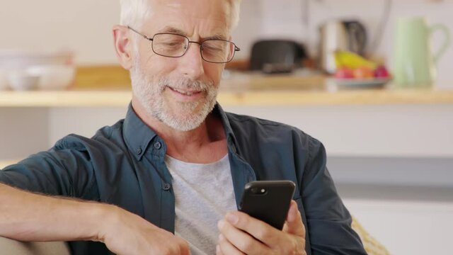 Man hands holding smartphone while order food delivery at home. Mature man using mobile app with smart phone to order lunch. Man sending email at home with cellphone