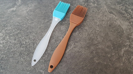 The cooking brush used in cooking for greasing lies on a dark background