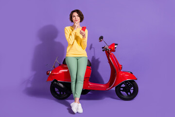 Obraz na płótnie Canvas Full length body size view attractive cheery minded pensive girl sitting on bike using gadget creating blog post isolated over bright vivid shine vibrant lilac violet purple color background
