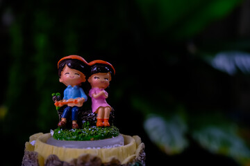 Doll men and women.Happily sitting in the garden