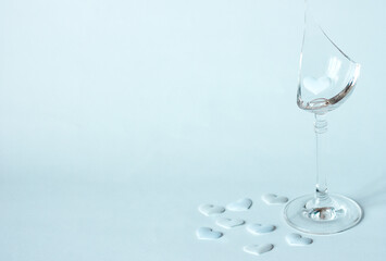 Broken glass and decorative heart on blue background, copy space for text