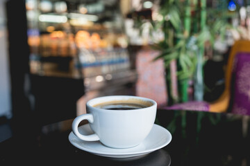 Hot black coffee on table in cafe