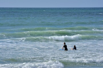 People practising surf on a beach in Brittany. France