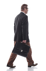 side view. successful businessman with a leather briefcase stepping forward