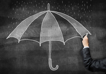 Businessman hand with chalk draws umbrella sketch