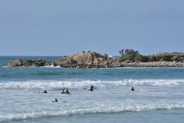 People practising surf on a beach in Brittany. France