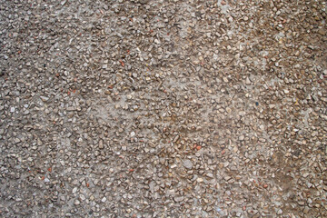 Background of small stones, gravel on the cement. Stone brown background.