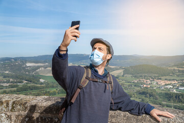 A man taking a picture of himself with a panoramic view.