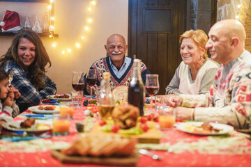 Happy family having Christmas dinner at home - Holiday concept - Focus on grandfather