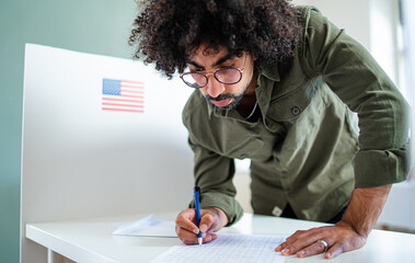 Man voter in polling place, usa elections concept.
