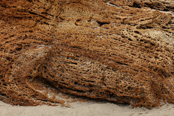 Different texture on the beach - water and sand, stones and pebbles, waves and splashes.