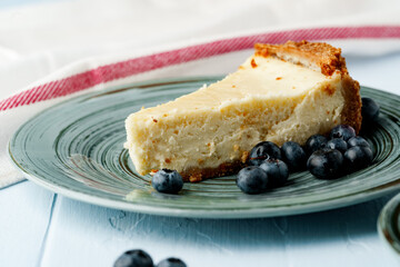 Piece of classic cheesecake on green plate