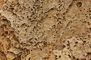 Different texture on the beach - water and sand, stones and pebbles, waves and splashes.