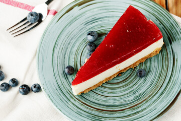 Layered mousse cake piece with berry topping