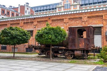 an old rusty spark-free locomotive standing on the promenade in Żyrardów