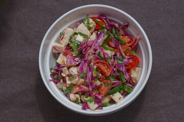 fresh vegetable salad in a white plate on the table