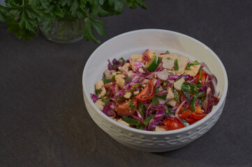 fresh vegetable salad in a white plate on the table