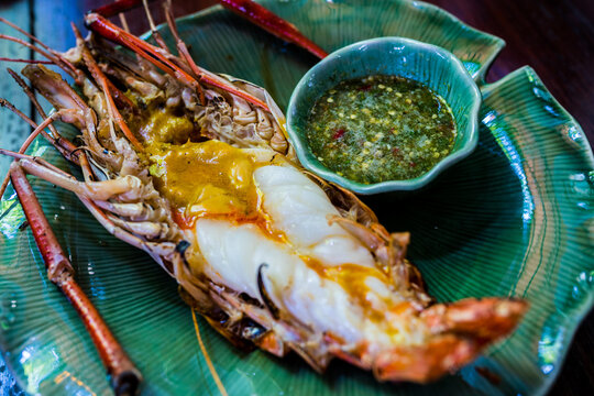 Thai cuisine food, grilled prawns with spicy sauce close up