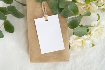 Thank you gift tag mockup for wedding, bridal shower, rustic wedding favor tag, rectangle 2x3" label mock up on kraft paper box, eucalyptus branches, white flowers.