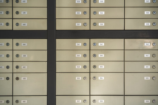 Gray mailboxes with locks and numbers
