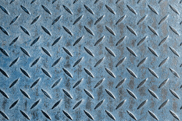 Abstract background of old blue rusty diamondplate rusty metal panel. Grunge brown rough grip industrial steel texture pattern